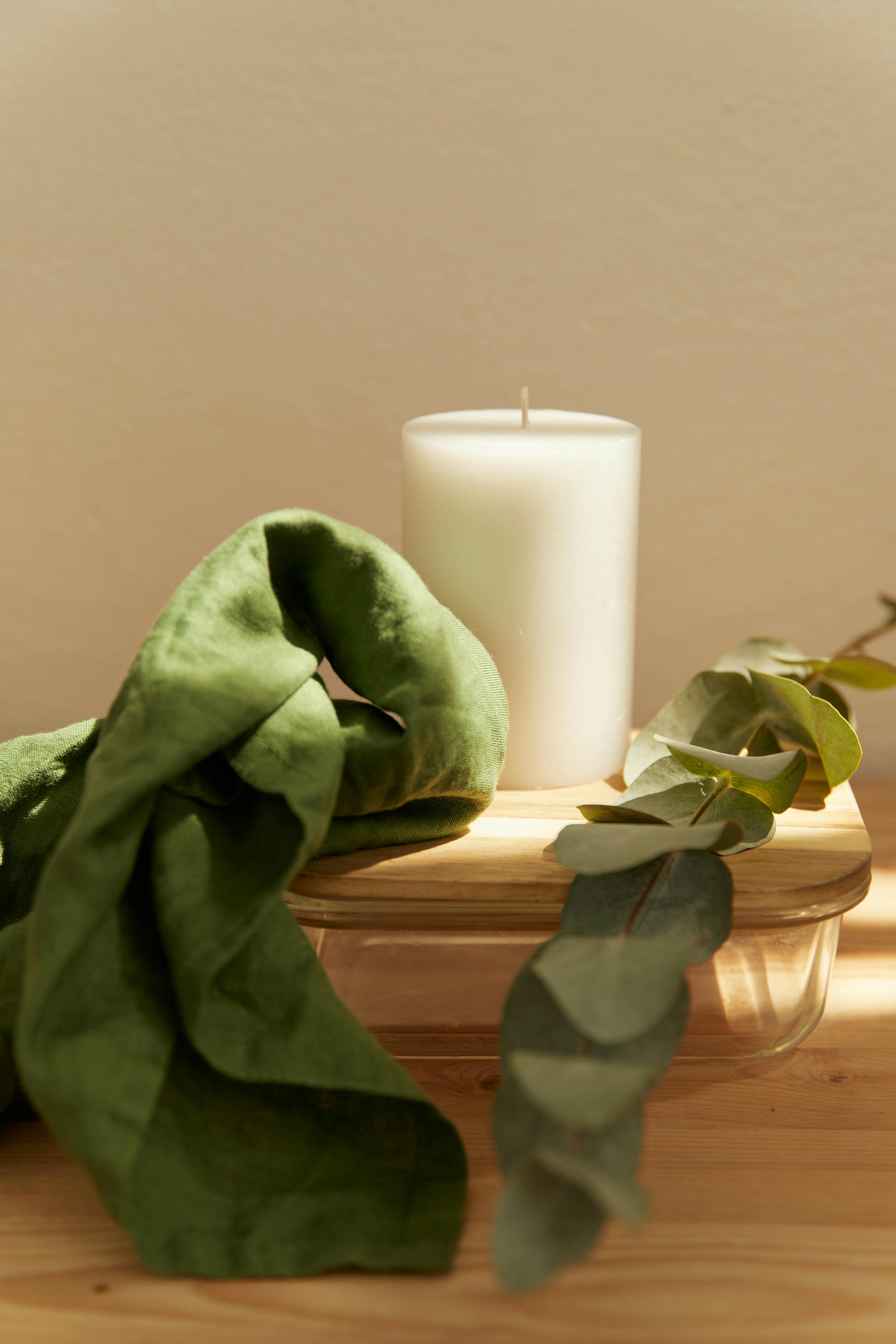 Free stock photo of a calm spa still life with candles and folded towels used as a demo image